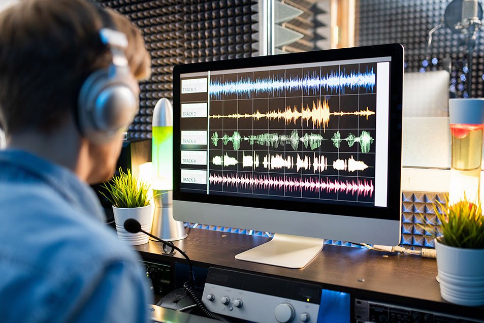AdobeStock_291027258-72 Sound editor working at the digital audio workstation.